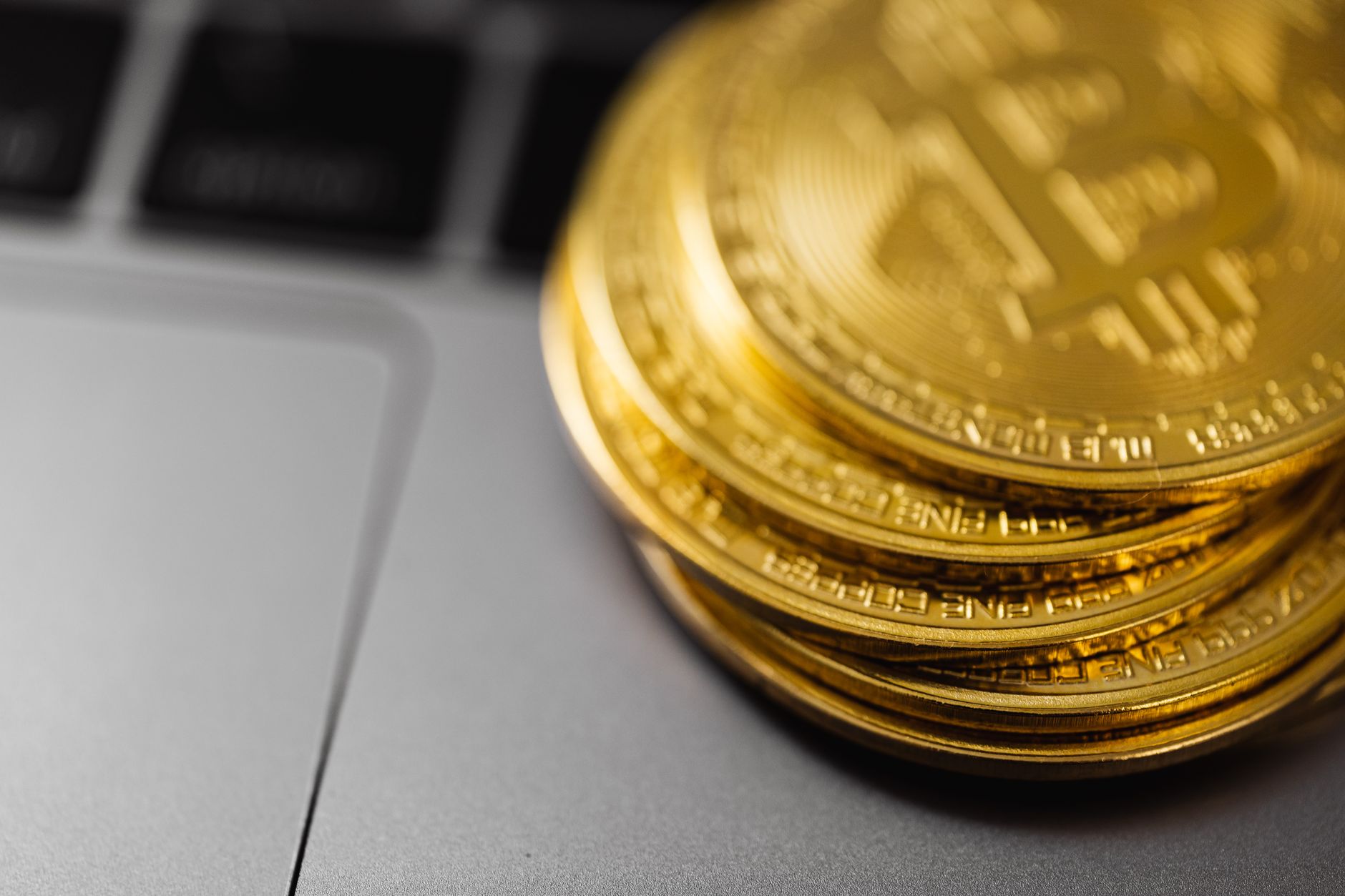 Gold Bitcoin coins stacked on a reflective surface representing crypto treasury holdings