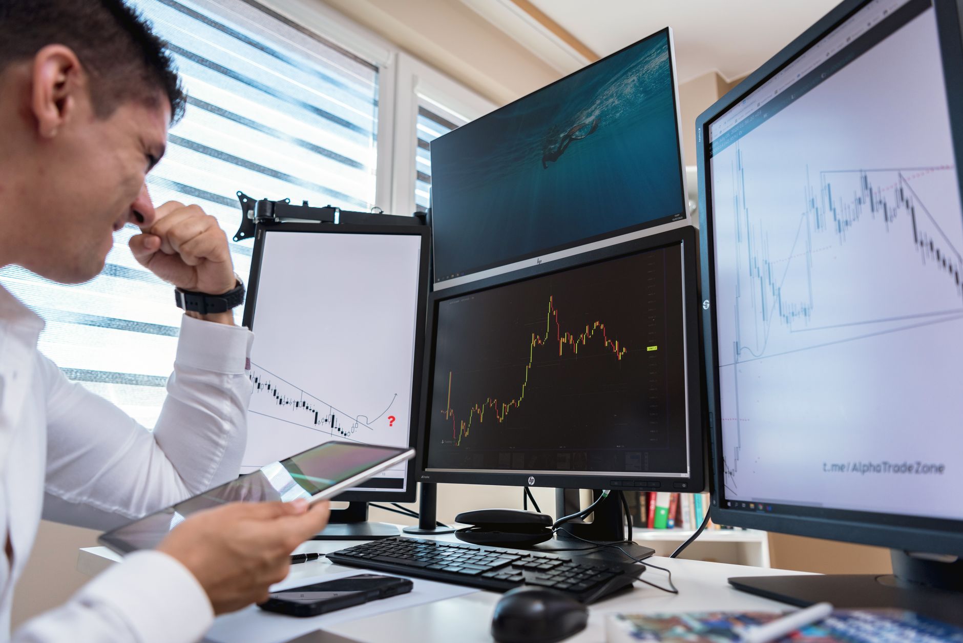 Professional trader analyzing cryptocurrency market data on multiple screens