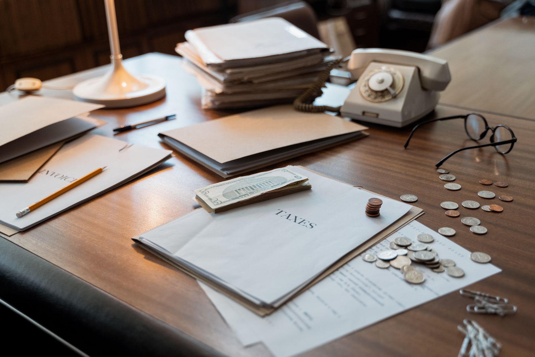 Cryptocurrency tax reporting documents and digital asset forms on desk