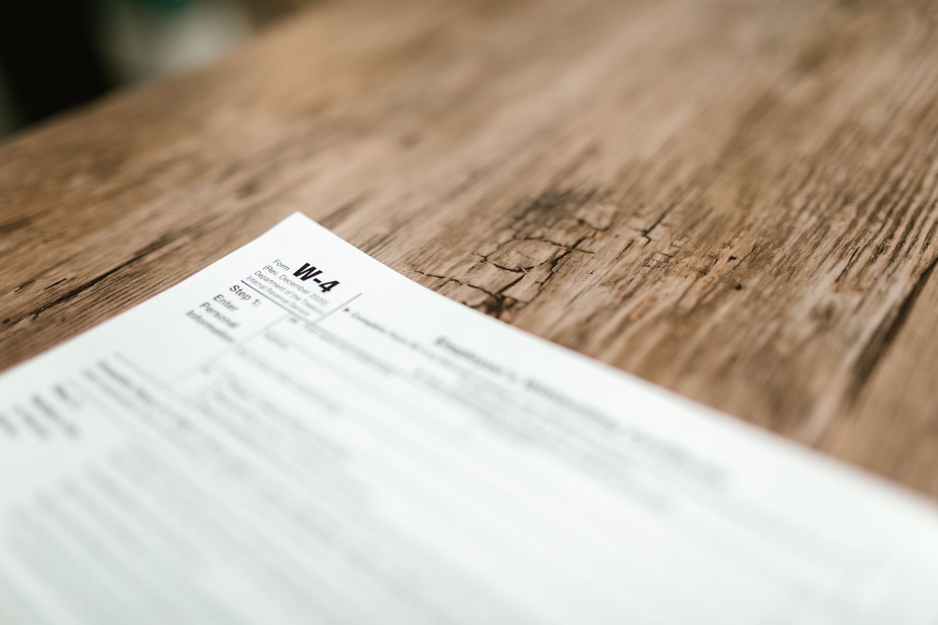 Business professional reviewing financial compliance paperwork at desk