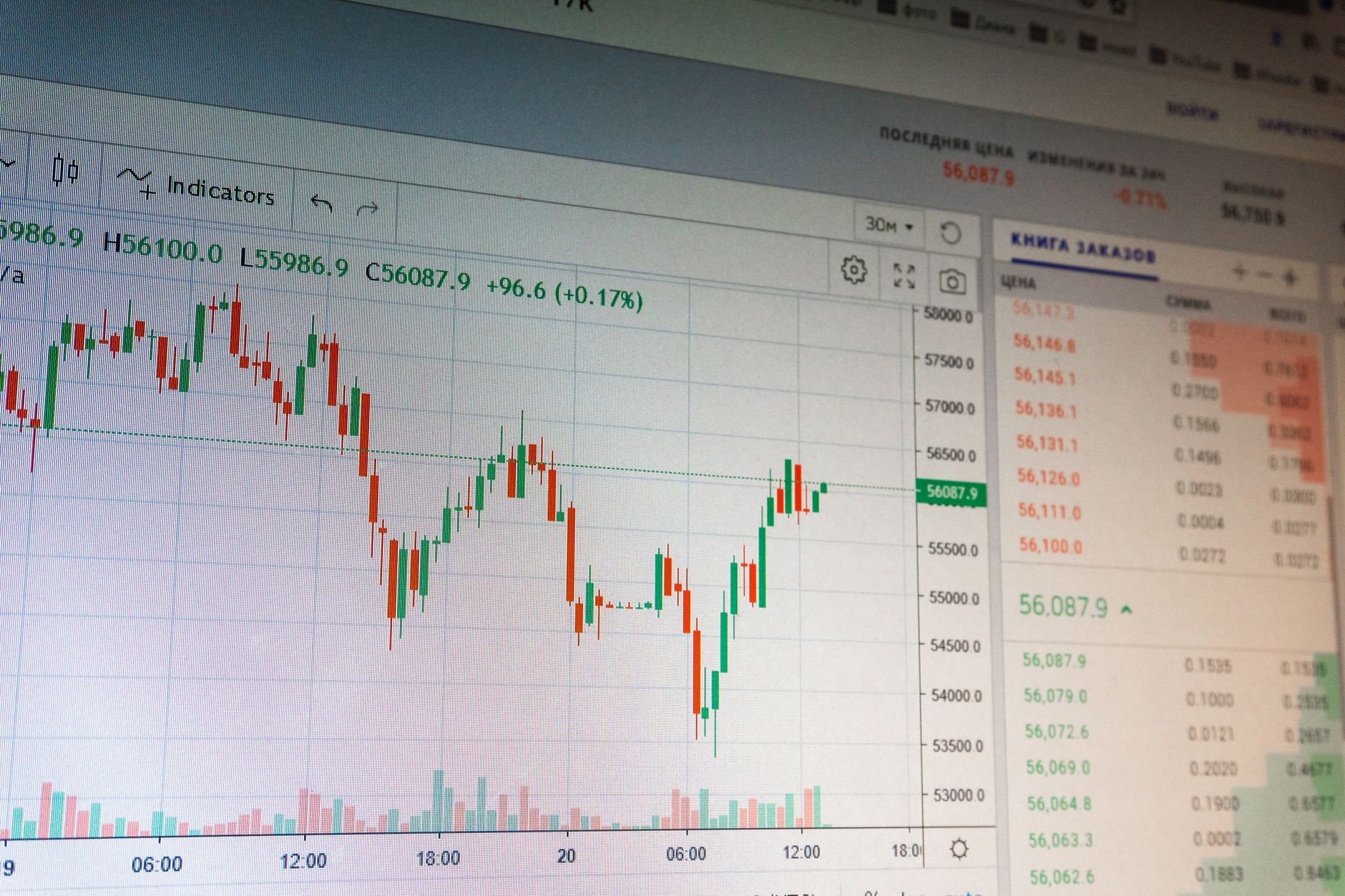 Financial market screens displaying tokenized stock and trading volume data