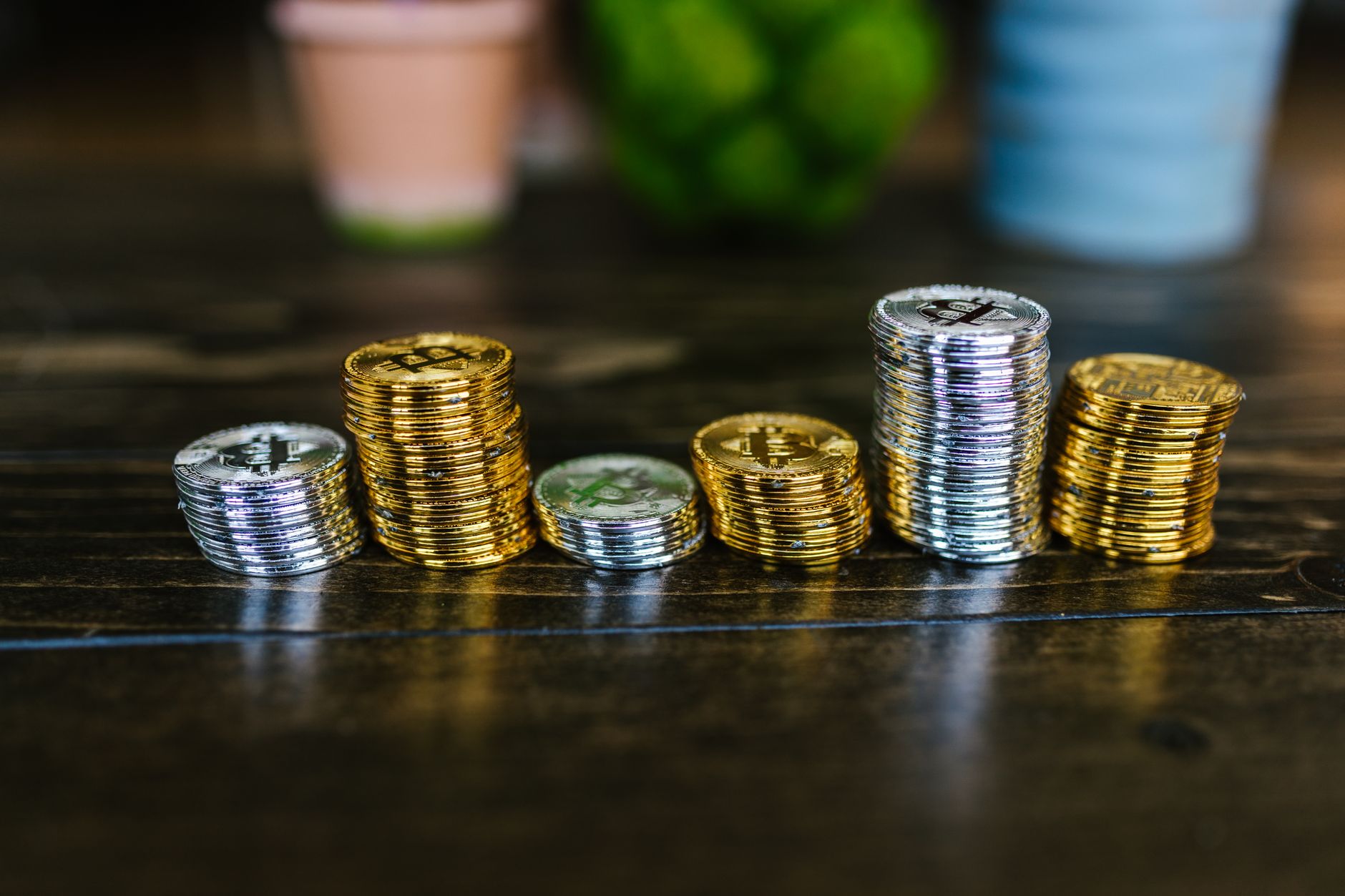 Cryptocurrency coins on a desk representing crypto tax policy debate in Congress