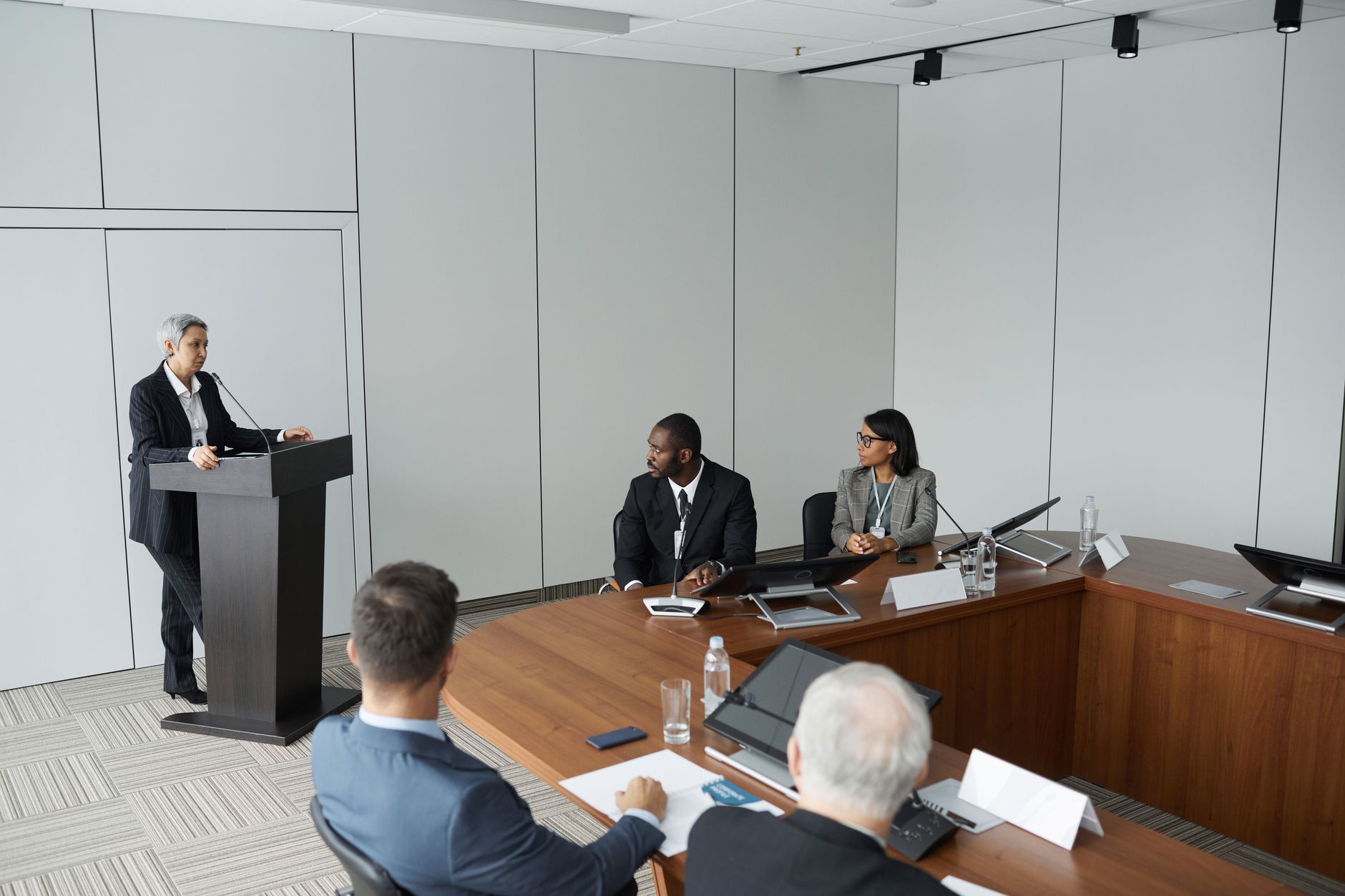 Financial industry executives meeting around a table representing strategic investor working group