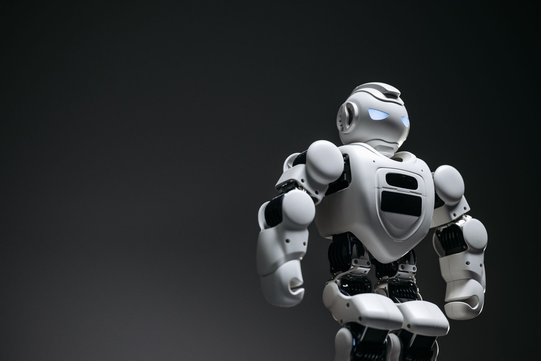 Humanoid robot interacting with digital interface representing AI agents