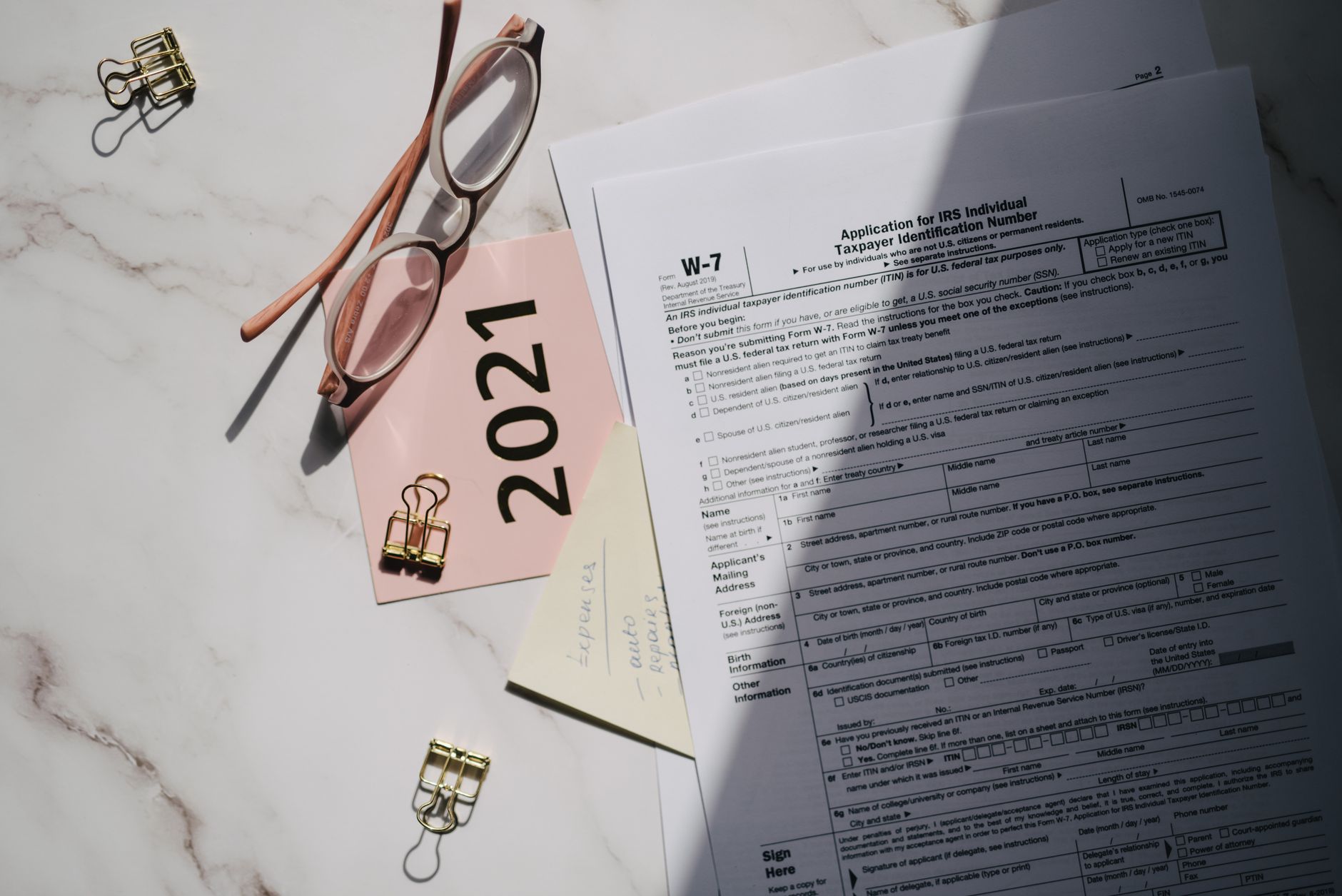 Person reviewing digital compliance documents on a tablet in a formal financial setting