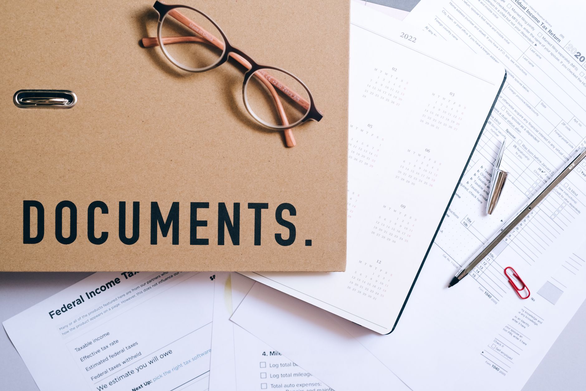 Regulatory documents and financial compliance paperwork on a desk