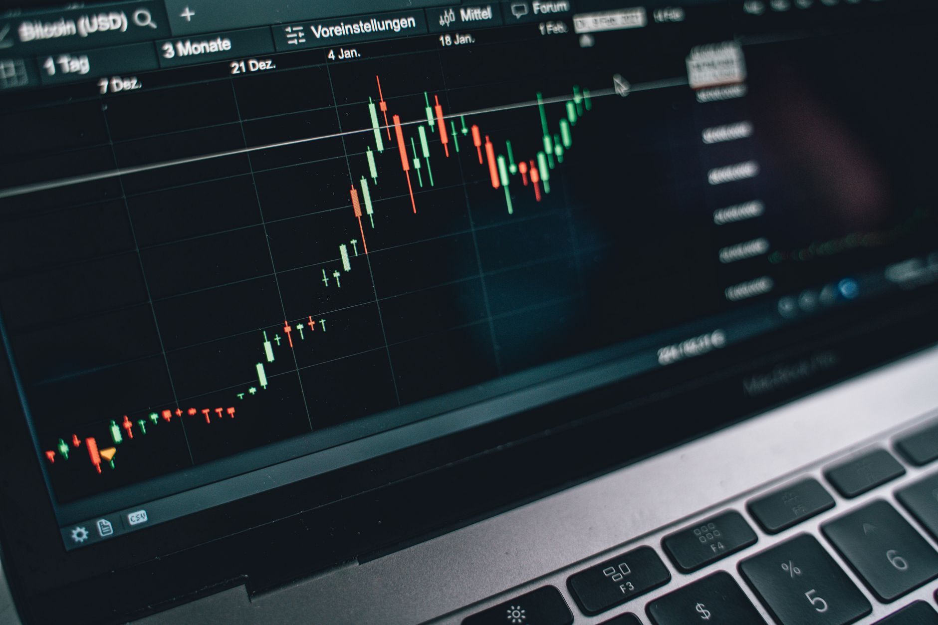 Financial analyst reviewing cryptocurrency exchange data on multiple monitors