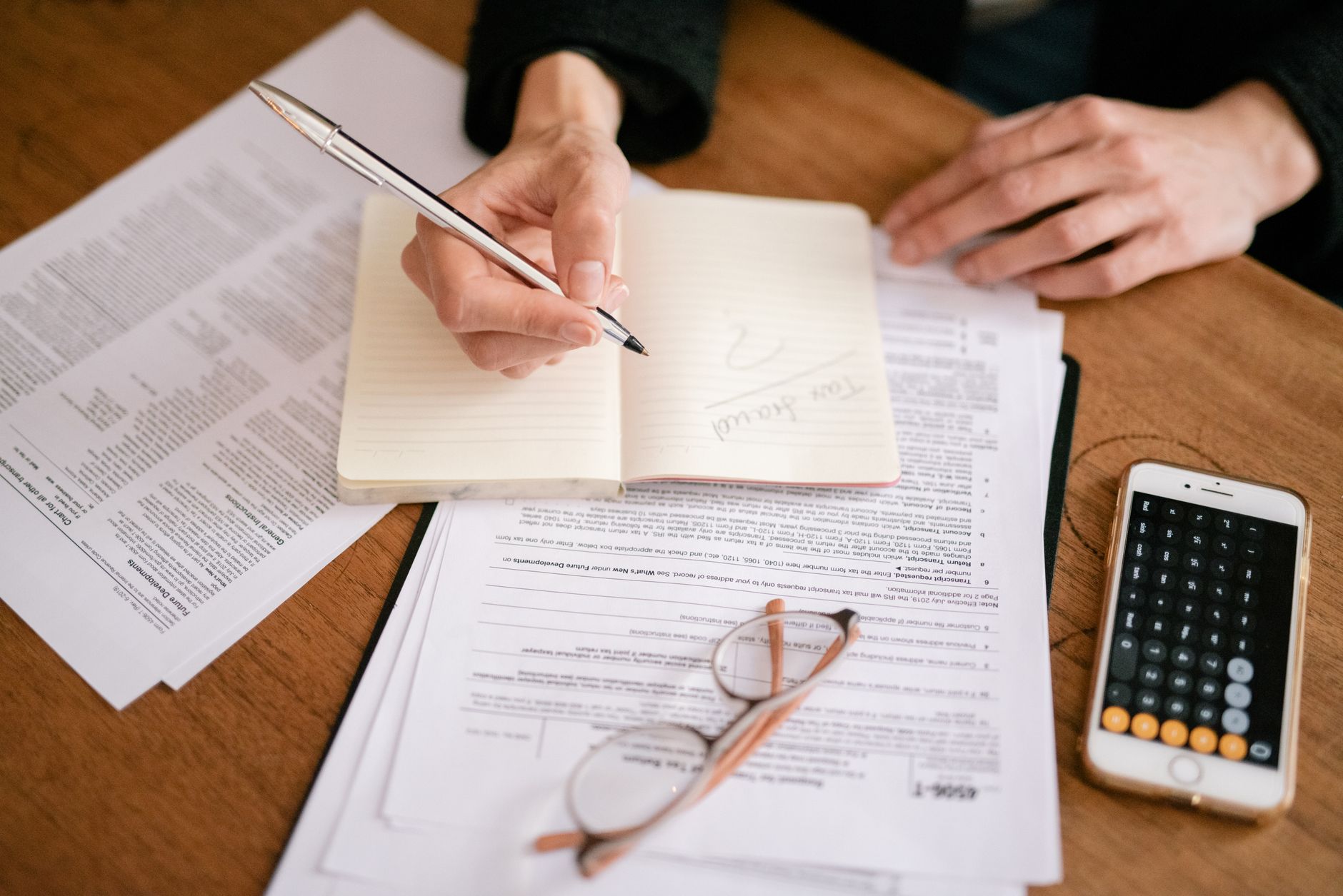 Tax reporting documents on a desk representing crypto compliance obligations