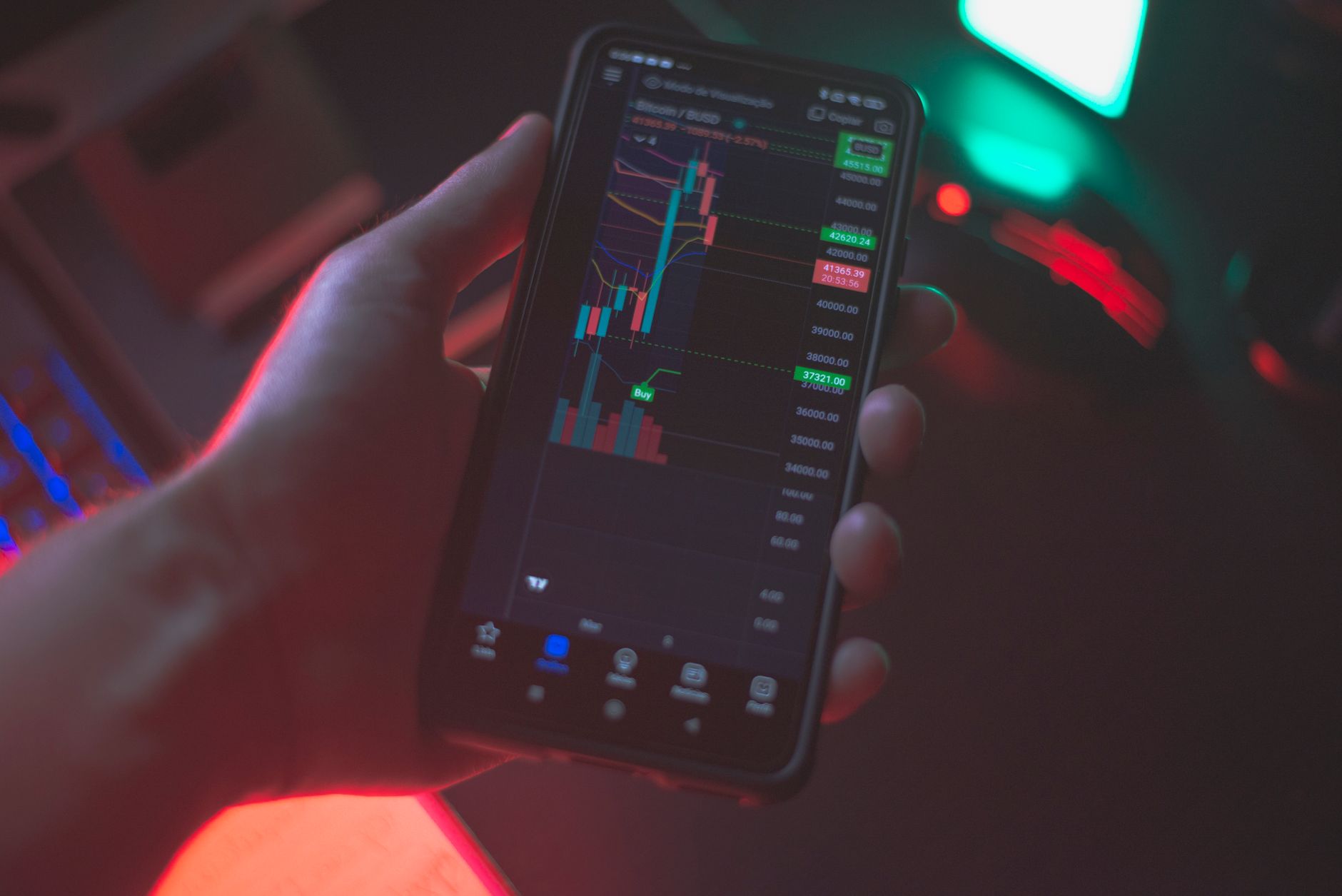 Person viewing cryptocurrency wallet and sports betting app on a mobile phone