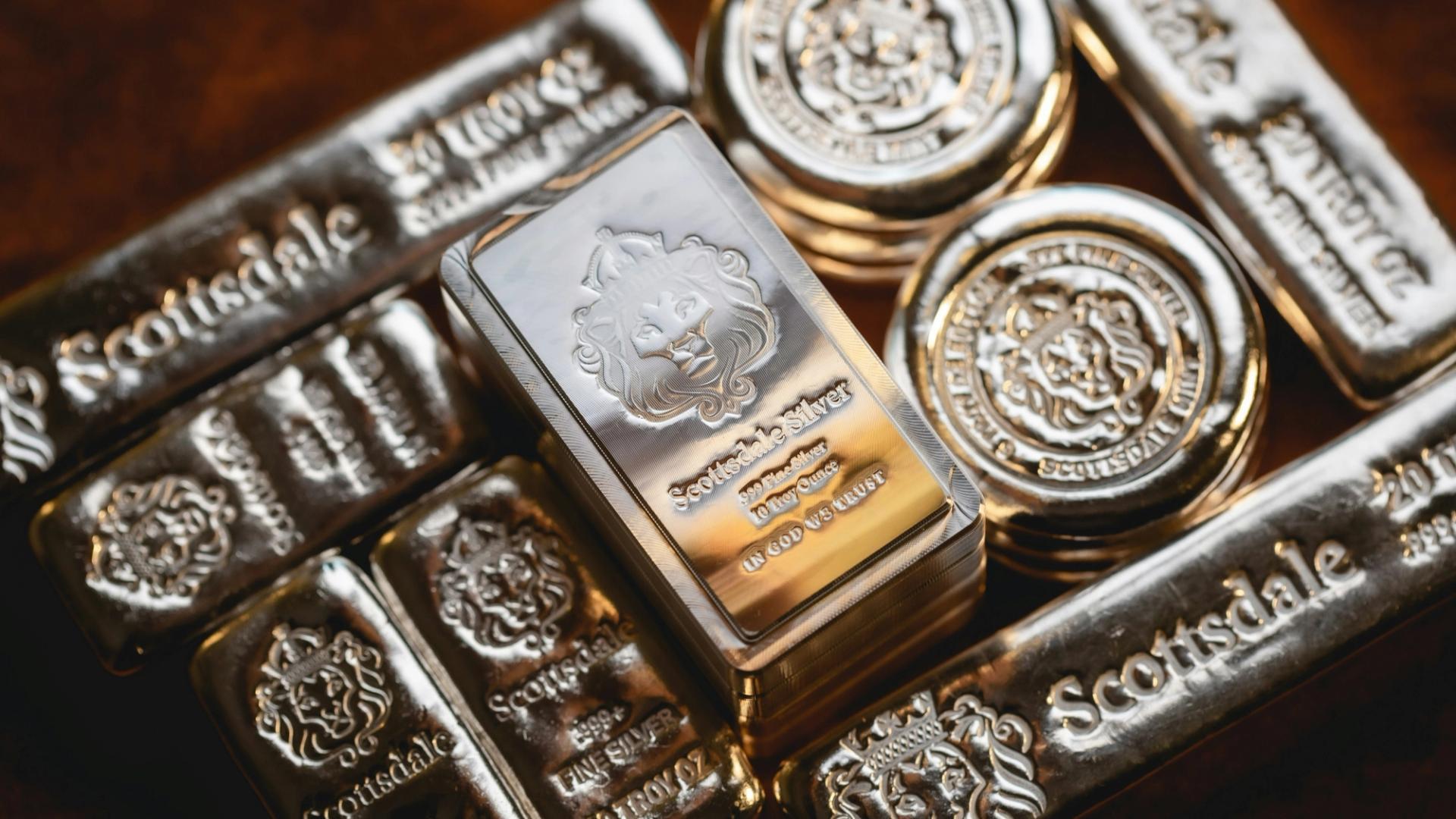 Polished silver bars stacked representing physical commodity assets